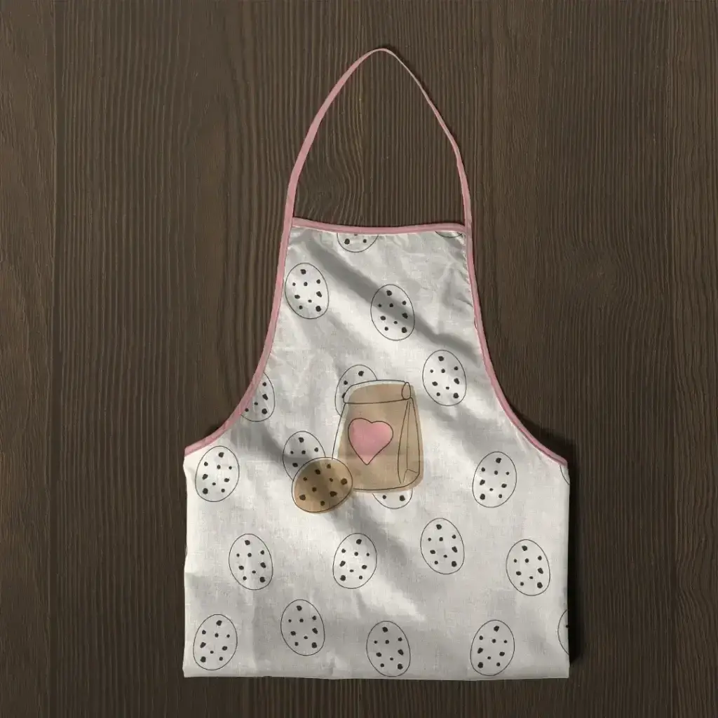 Tablier de cuisine illustré du logo Brunchez-vous et de motifs de cookies.